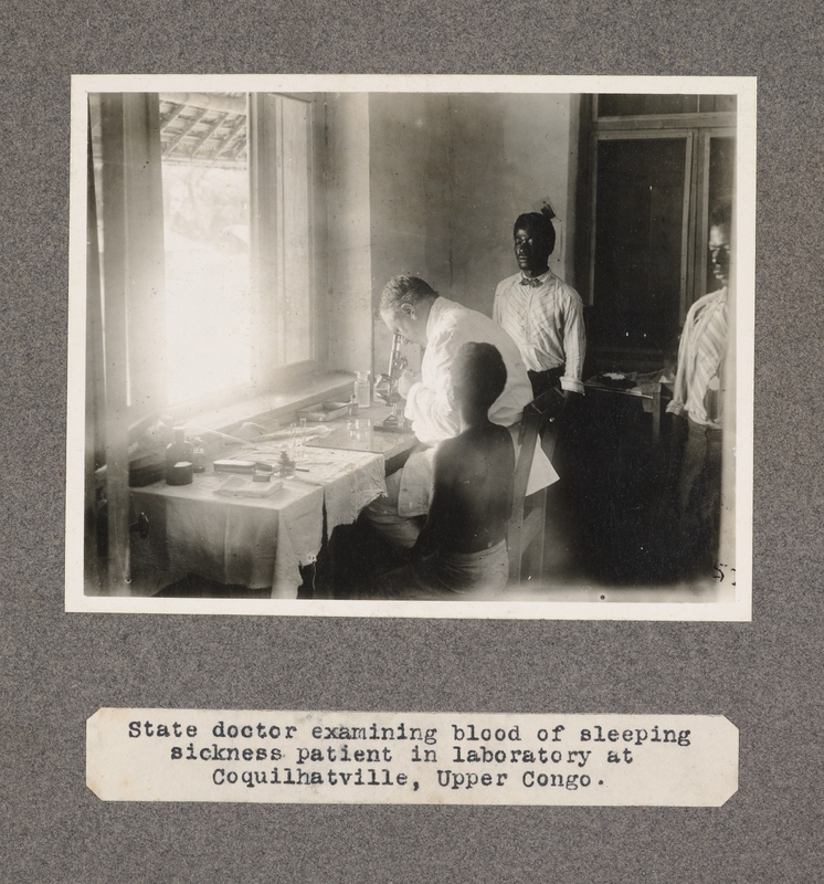 State doctor examining blood of sleeping sickness patient in laboratory at Coquilhatville, upper Congo