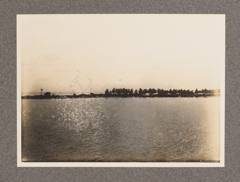 No caption [view of village and landscape taken onboard a boat, similar to number 35]