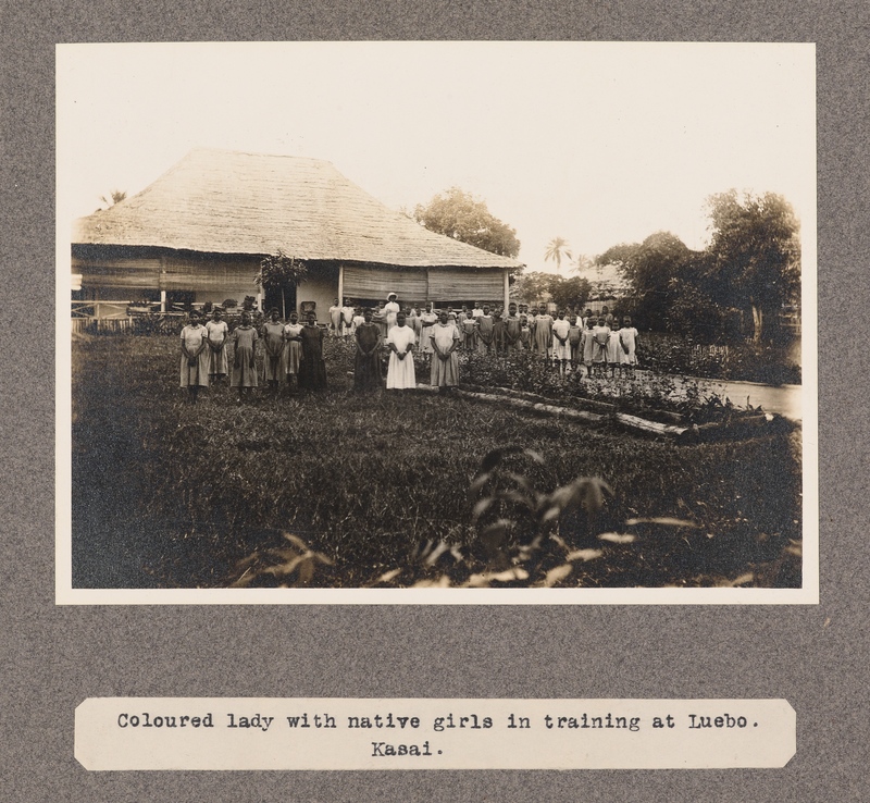 Coloured lady with native girls in training at Luebo, Kasai