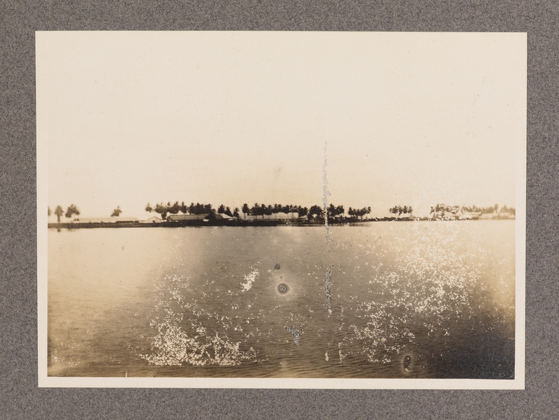 No caption [view of village and landscape taken onboard a boat, similar to image 37]