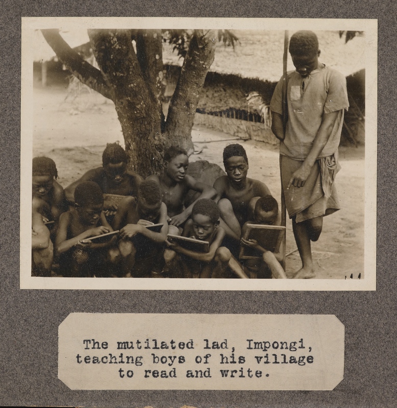 The mutilated lad, Impongi, teaching boys of his village to read and write