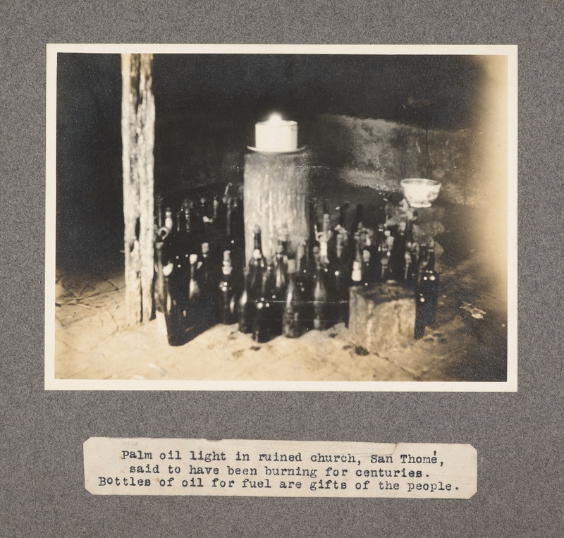 Palm oil light in ruined church, San Thomé, said to have been burning for centuries. Bottles of oil for fuel are gifts of the people