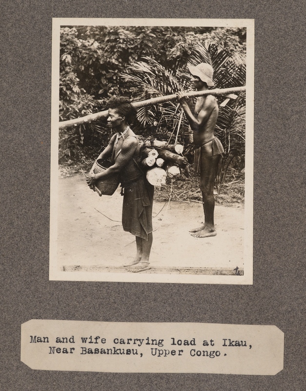 Man and wife carrying load at Ikau, near Basankusu, upper Congo