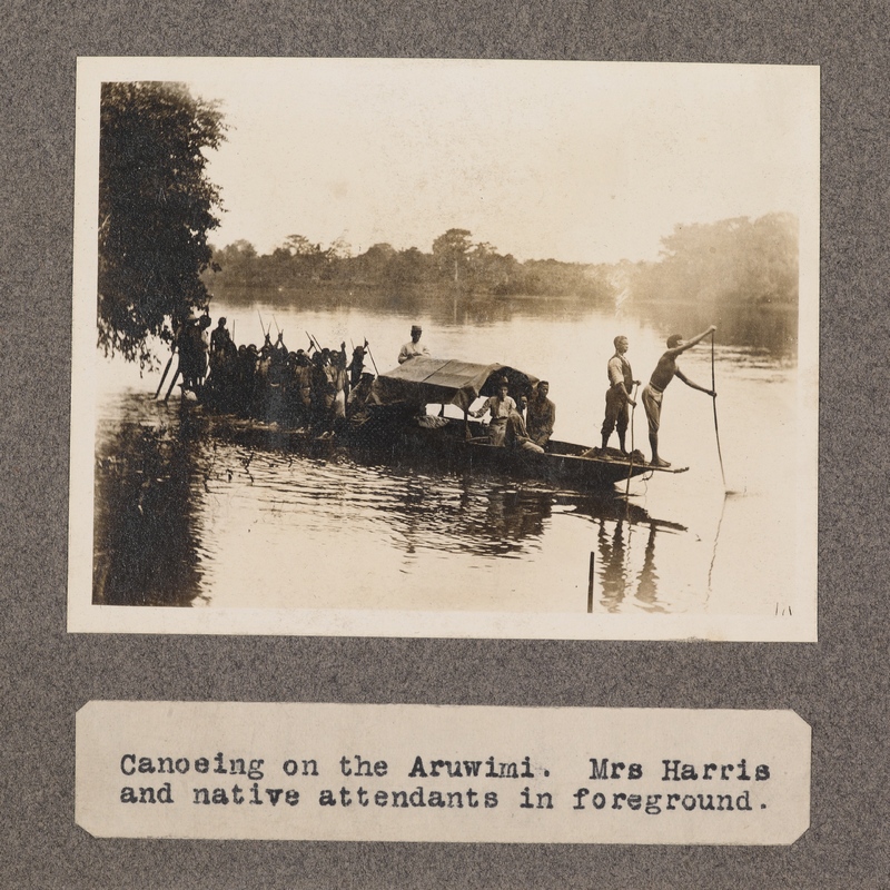 Canoeing on the Aruwimi. Mrs. Harris and native attendants in foreground