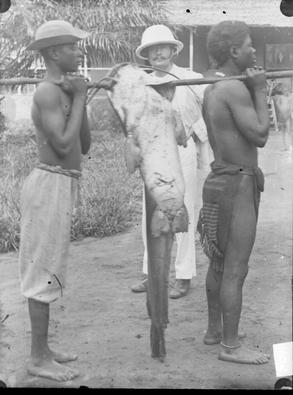 John Harris with Two African Men Holding a Large Fish