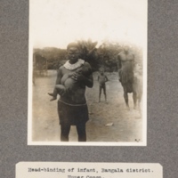 Head-binding of infant, Bangala district. Upper Congo